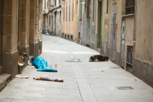 homeless person in blue sleeping bag